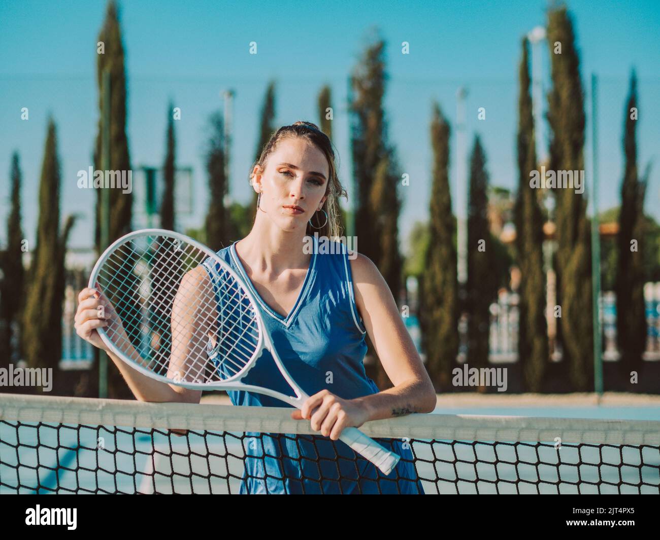 Photo Poses With Racket A young female with racket posing on tennis court Stock Photo - Alamy