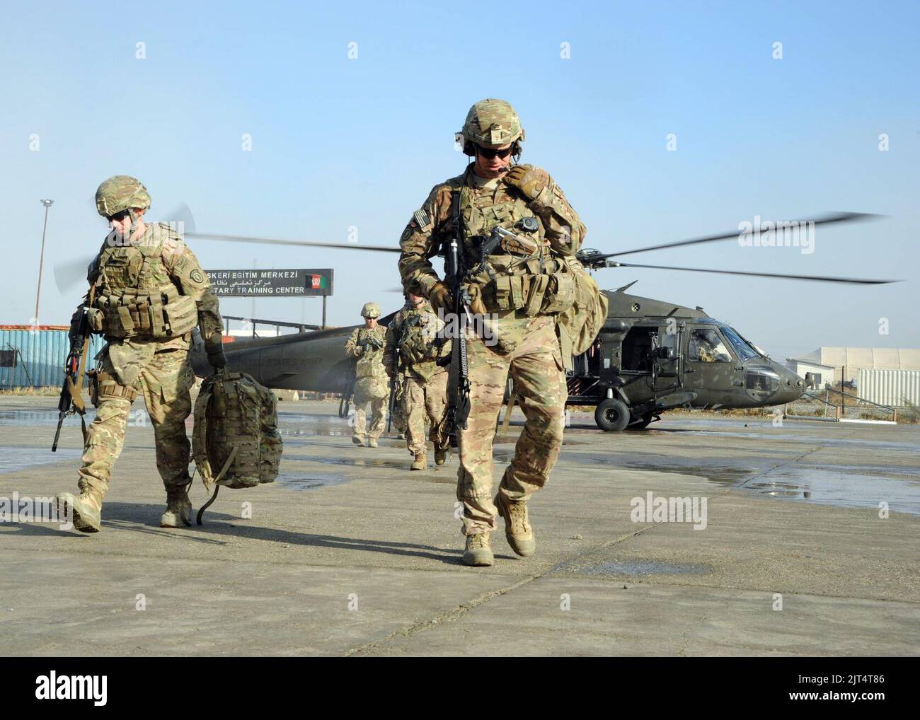 U.S. Army Col. Peter Andrysiak, center, the commander of the 2nd Engineer Brigade, and members of his staff exit a UH-60 Black Hawk helicopter after landing at Camp Ghazi, Kabul province, Afghanistan, Oct. 20 141020 Stock Photo