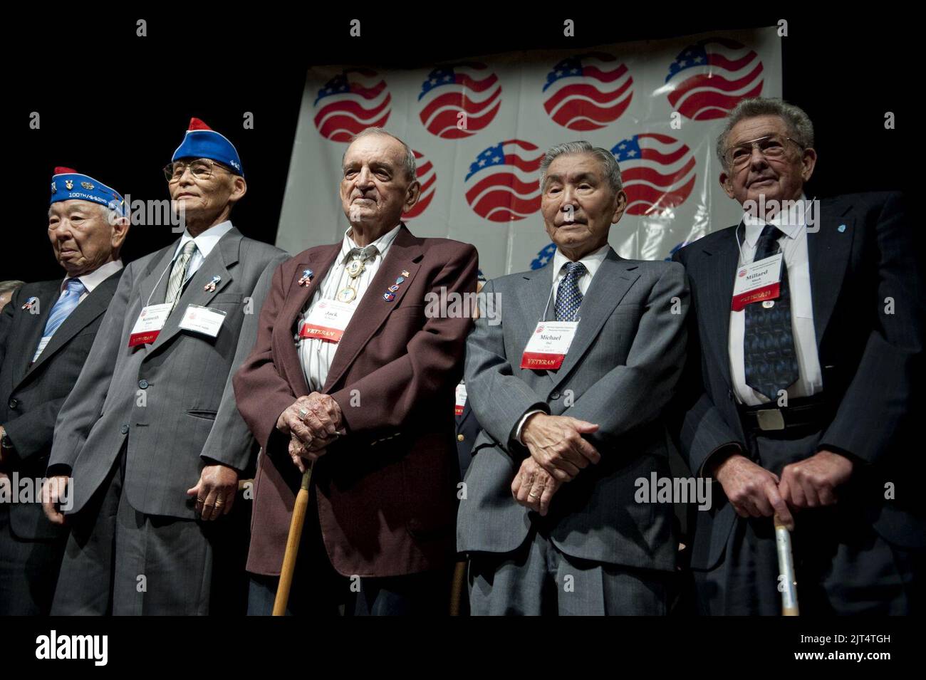 U.S. Army veterans from the 141st Infantry Regiment and the 442nd Regimental Combat Team stand during the 65th Anniversary Tribute dinner. Stock Photo