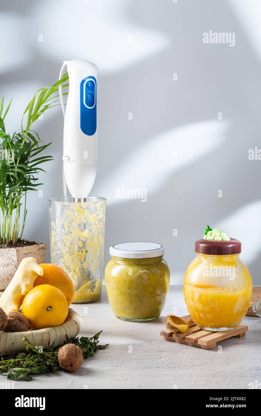 Blender in a bowl. Freshly made jam from honey, nuts and fruits. Ginger