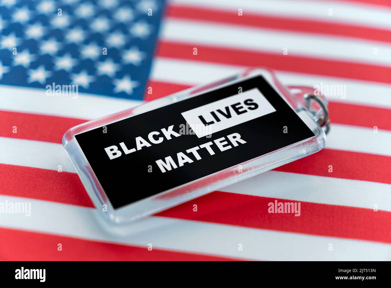a plastic keychain with the symbol of the BLM movement. black lives ...