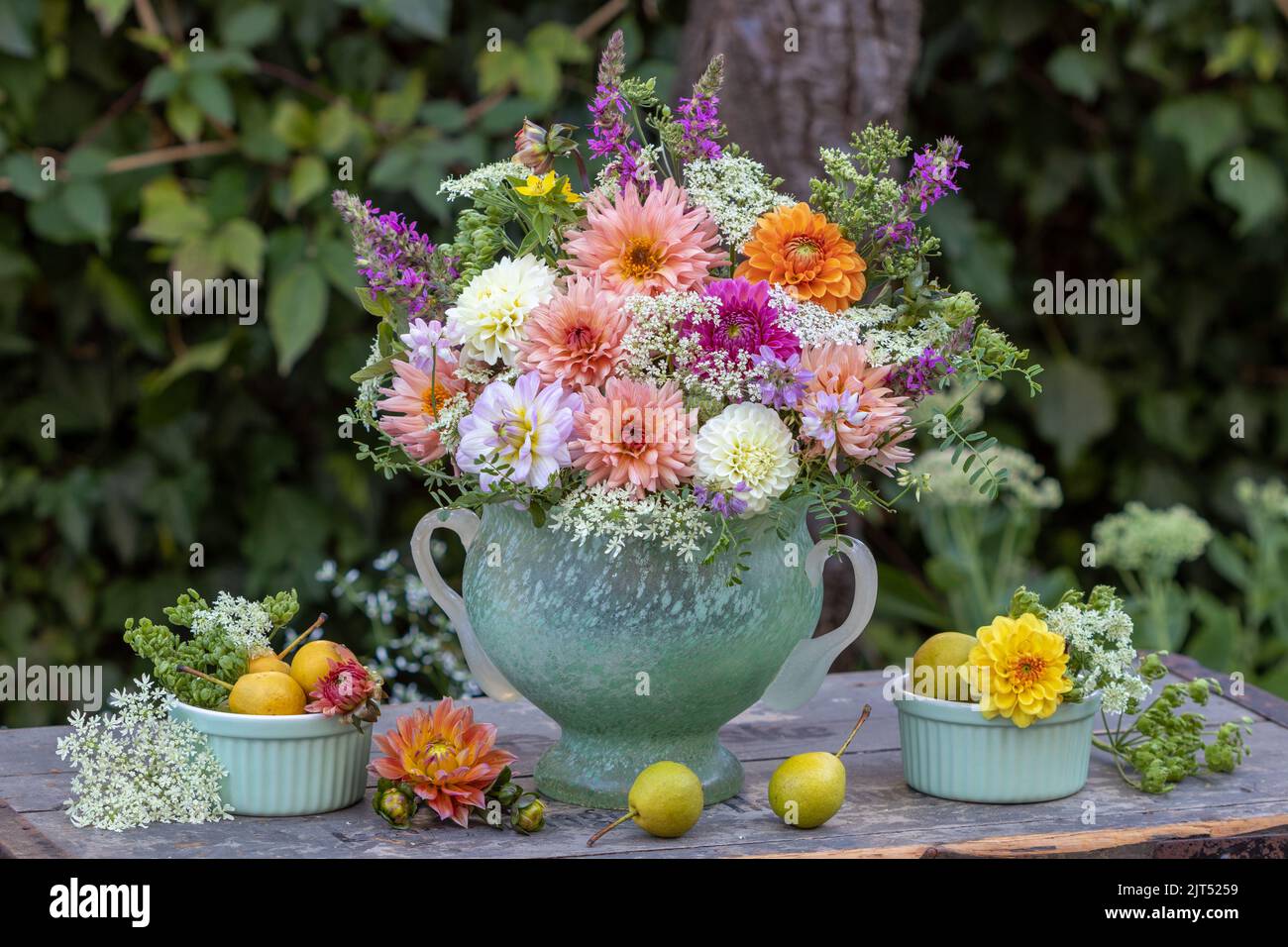 arrangement with bouquet of dahlia flowers, wild carrots and meadow sage Stock Photo