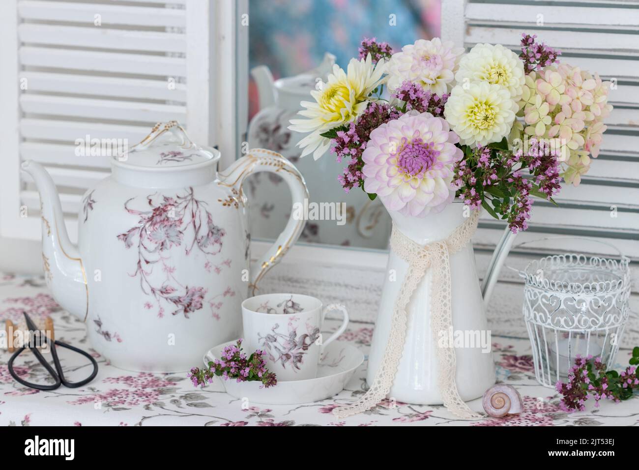 romantic arrangemenrt with bouquet of white and purple dahlias and vintage porcelain Stock Photo
