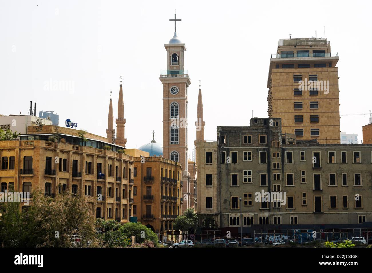 Beirut, Lebanon: Bell Tower of St. George Cathedral and the minarets of Mohammad Al-Amin Sunni Muslim Mosque (also called Blue Mosque) Stock Photo