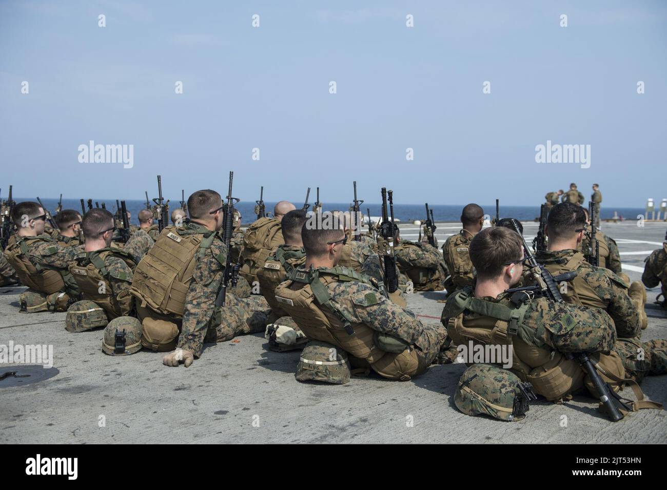 U.S. Marines assigned to Battalion Landing Team, 2nd Battalion, 5th Marine Regiment, 31st Marine Expeditionary Unit (MEU) prepare for a live-fire exercise aboard the amphibious transport dock ship USS Denver 140319 Stock Photo