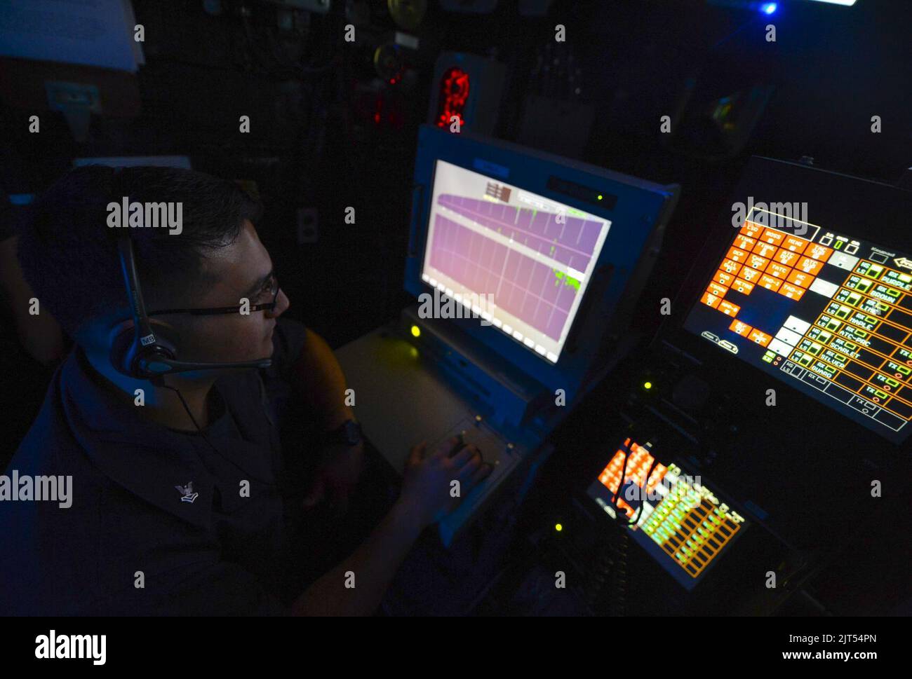 U.S. Navy Air Traffic Controller 2nd Class monitors air operations in the amphibious air traffic control center aboard the amphibious assault ship USS Bataan (LHD 5) March 23, 2014, in 140323 Stock Photo