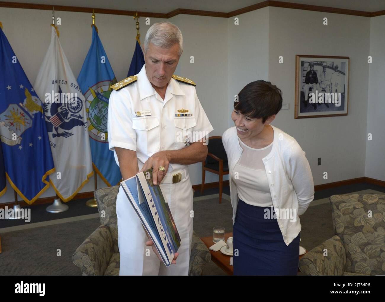 U.S. Navy Adm. Samuel J. Locklear, left, the commander of U.S. Pacific Command, gives a book to Norwegian Defense Minister Ine Eriksen Søreide during Rim of the Pacific (RIMPAC) 2014 at Camp H.M. Smith, Hawaii, J 140630 Stock Photo