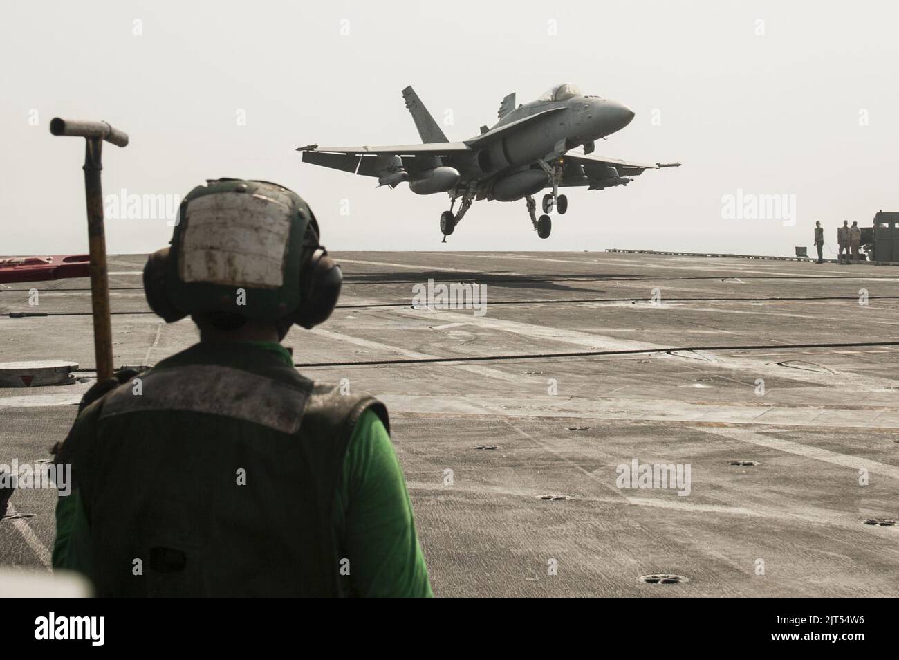 U.S. Navy Aviation Boatswain's Mate (Handling) 3rd Class watches an FA