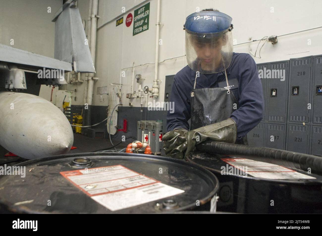 U.S. Navy Aviation Boatswain's Mate (Fuels) Airman pumps lube oil into