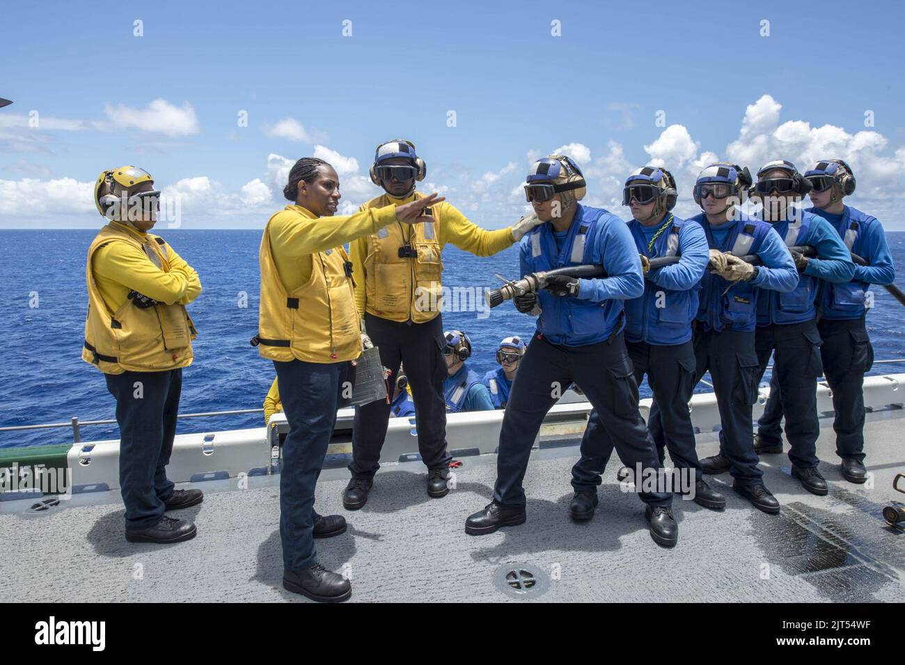 U.S. Navy Aviation Boatswain's Mate (Handling) 1st Class second from left, provides instruction
