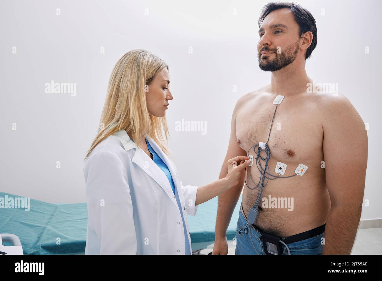 Cardiologist tracked adult man with heart condition using Holter monitoring with ECG sensors Stock Photo