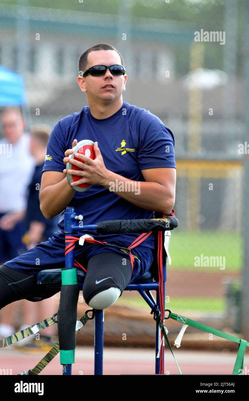 U.S. Navy Chief Yeoman prepares to perform a sitting discus throw