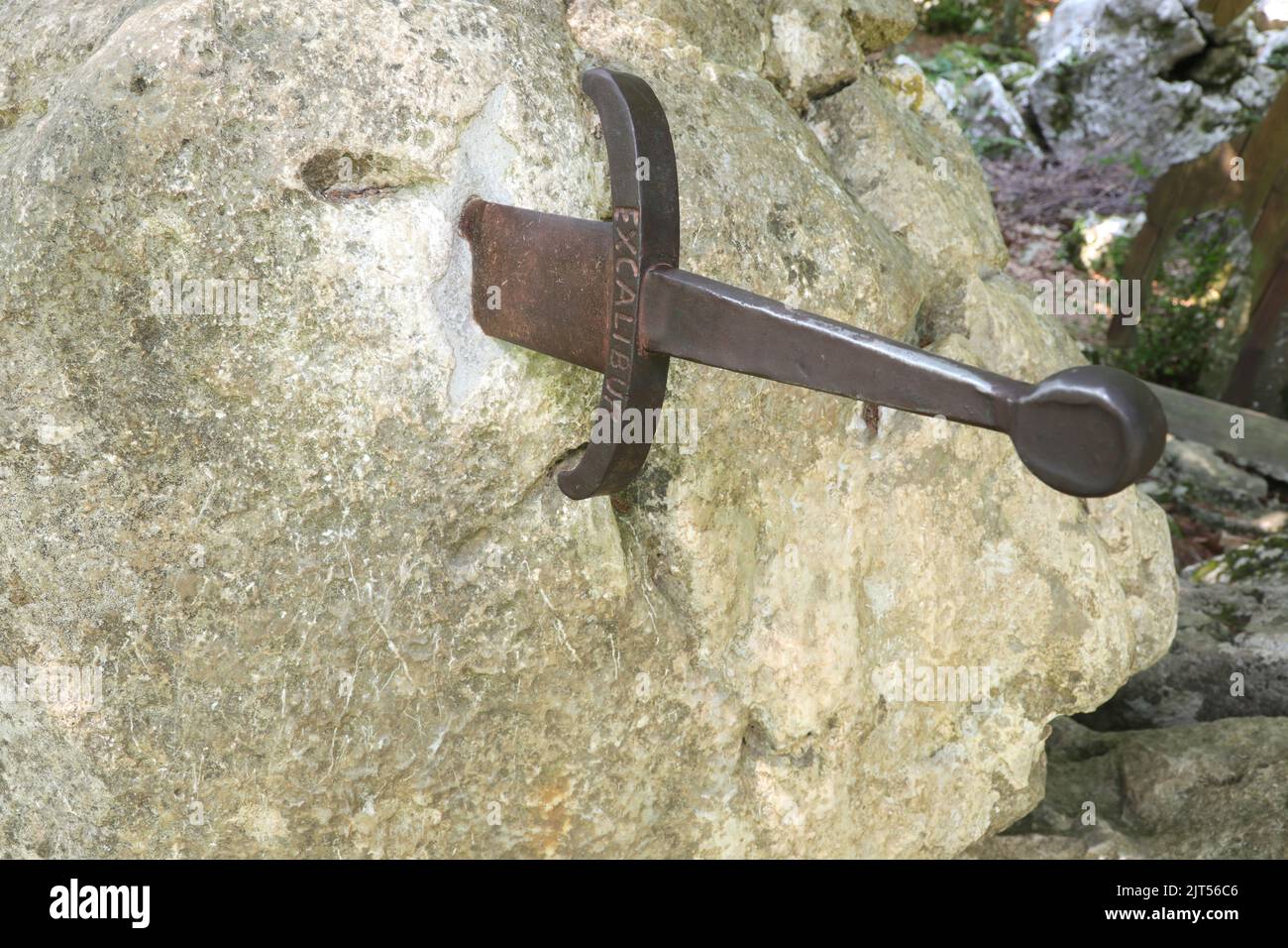sword with the word Excalibur stuck on the rock as in the legend of King Arthur of Camelot Stock Photo