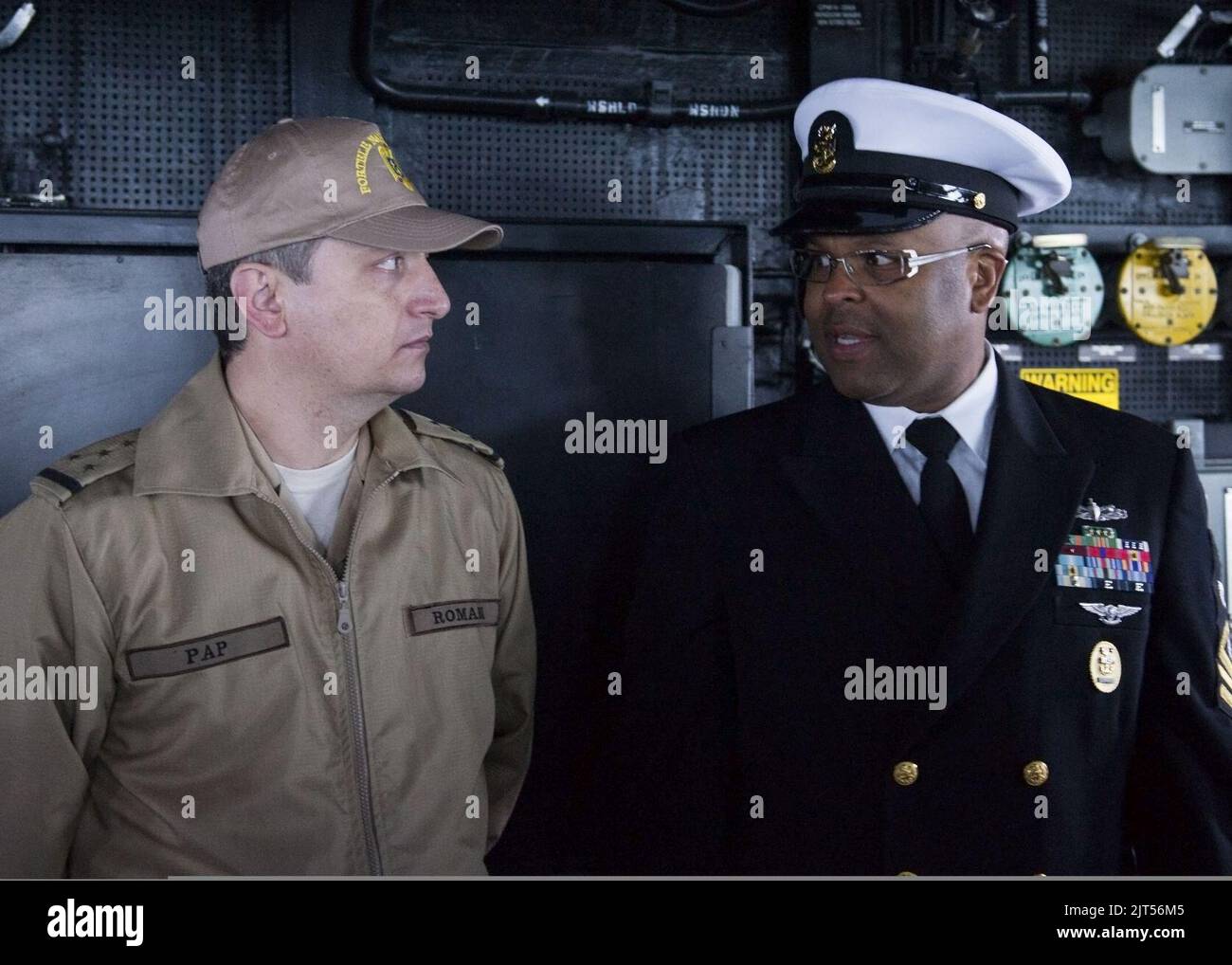 U.S. Navy Command Master Chief right, speaks with Romanian Navy Warrant ...