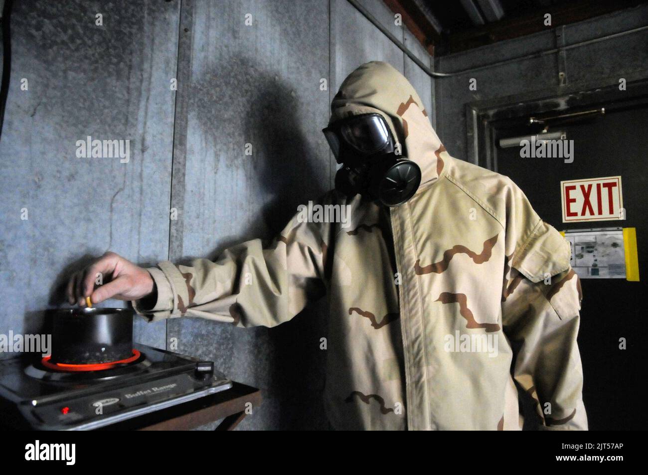 U.S. Navy Equipment Operator 2nd Class a Sailor with Naval Mobile Construction Battalion 5, activates CS gas during a gas mask training exercise in the confidence chamber at the Naval Construction 110224 Stock Photo