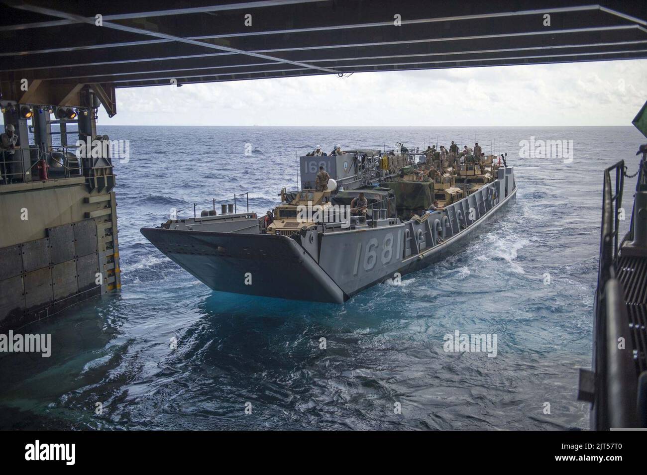 U.S. Navy Landing Craft Utility 1681 departs the well deck of the ...