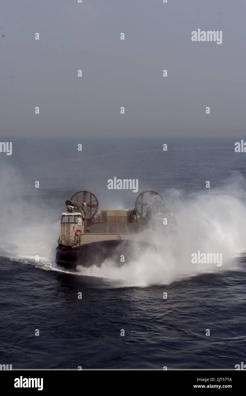 U.S. Navy Landing Craft, Air Cushion 9, assigned to Naval Beach Unit 7, prepares to enter the well deck of the amphibious assault ship USS Bonhomme Richard (LHD 6) in the East China Sea during Ssang Yong 14 as 140402 Stock Photo