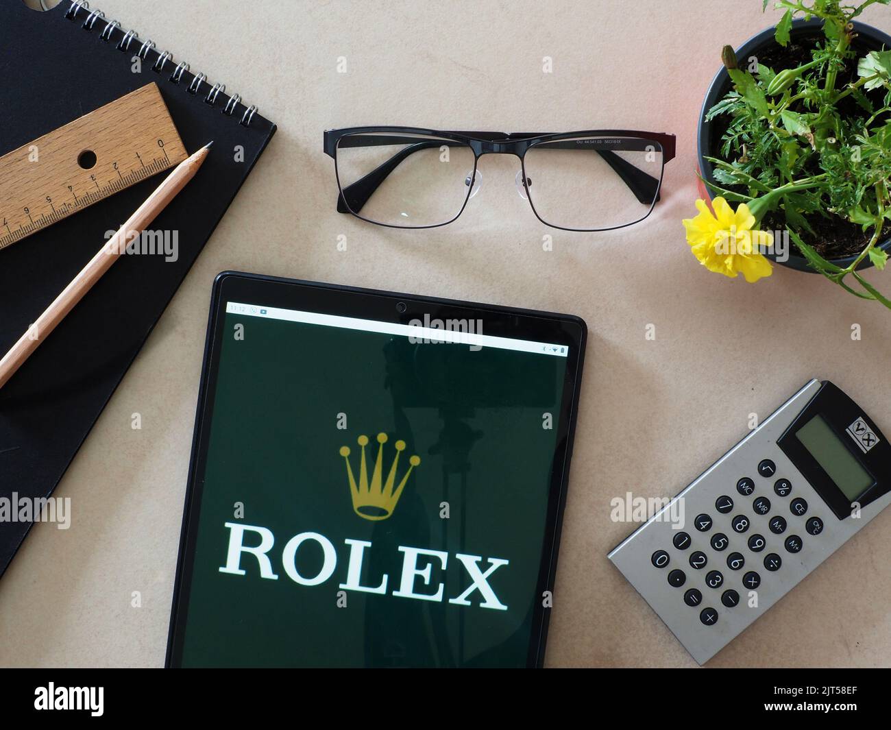 In this photo illustration,  Rolex SA logo seen displayed on a tablet Stock Photo