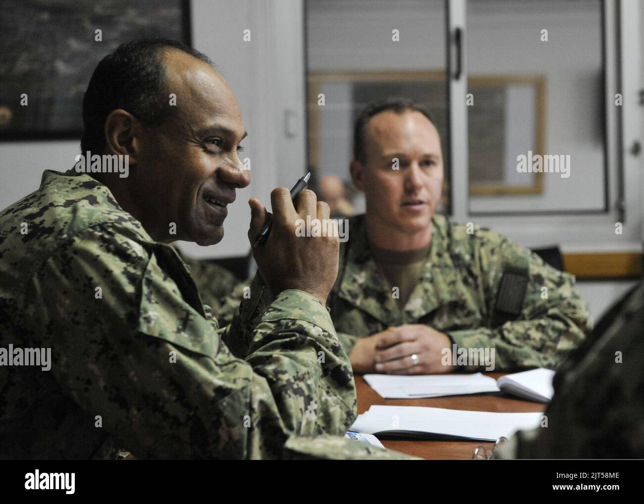 U.S. Navy Rear Adm. Vincent Griffith, left, the commander of Naval Supply Systems Command, Global Logistics Support, attends a briefing on Camp Lemonnier logistics operations during a tour of the camp 140115 Stock Photo
