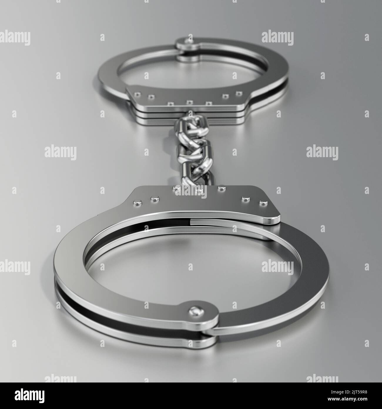 Handcuffs standing on gray background. 3D illustration. Stock Photo