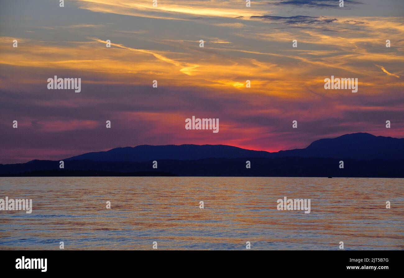 Sunset on a lake in Italy in summer Stock Photo