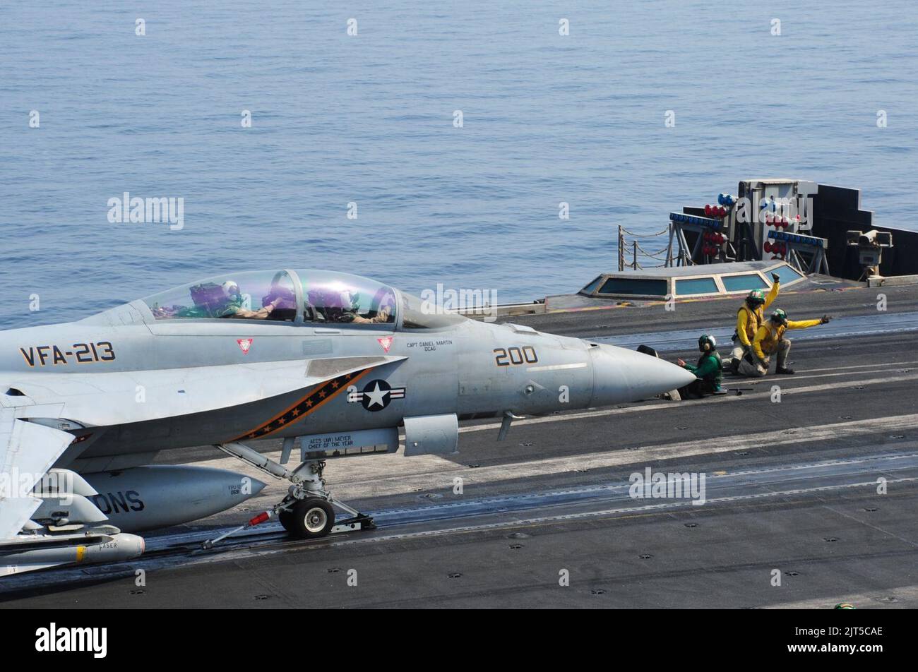 U.S. Sailors launch an F-A-18F Super Hornet aircraft assigned to Strike Fighter Squadron (VFA) 213 from the flight deck of the aircraft carrier USS George H.W. Bush (CVN 77) in the Persian Gulf Oct. 18, 2014, as Stock Photo
