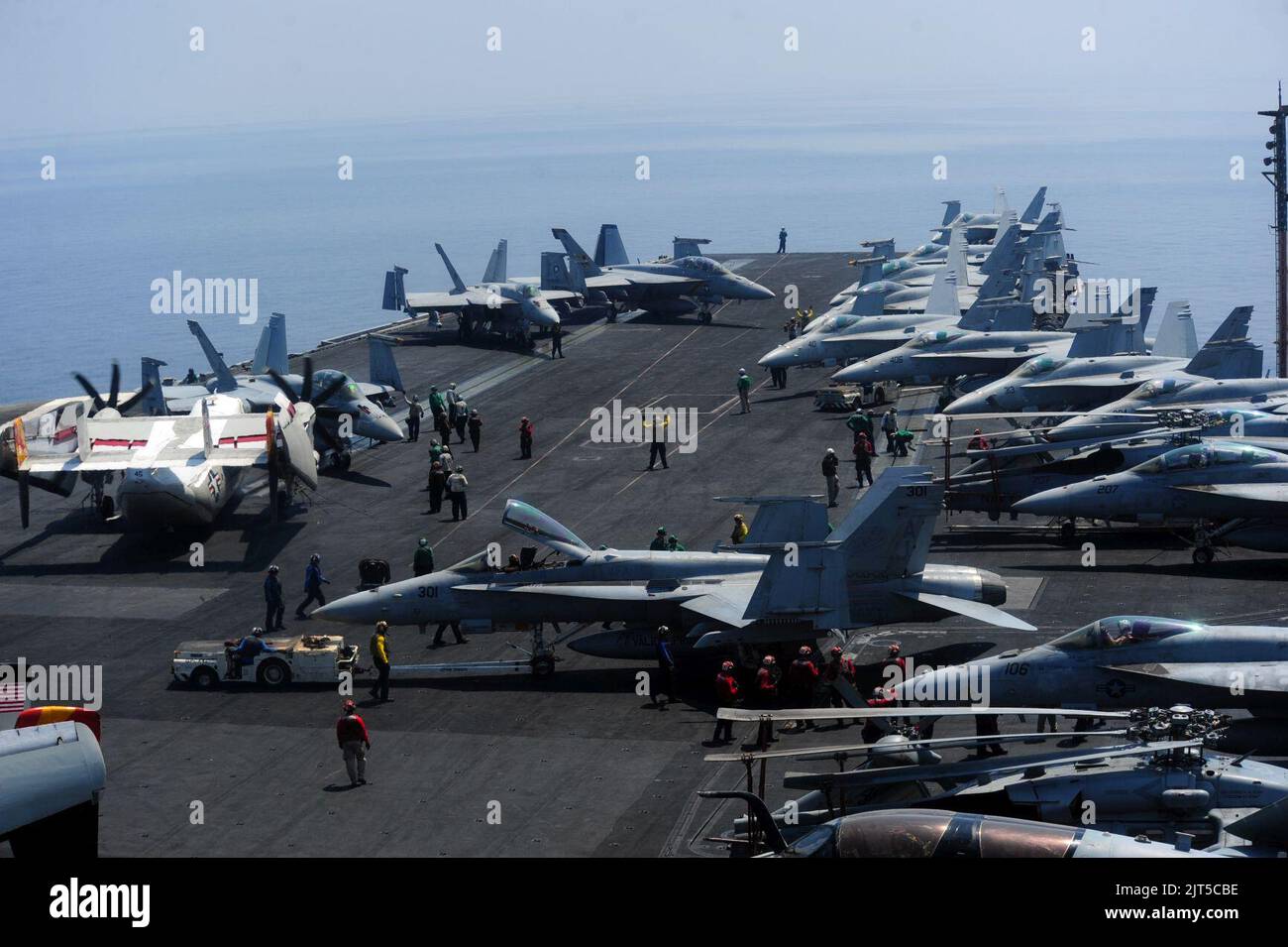 U.S. Sailors move aircraft aboard the aircraft carrier USS George H.W ...