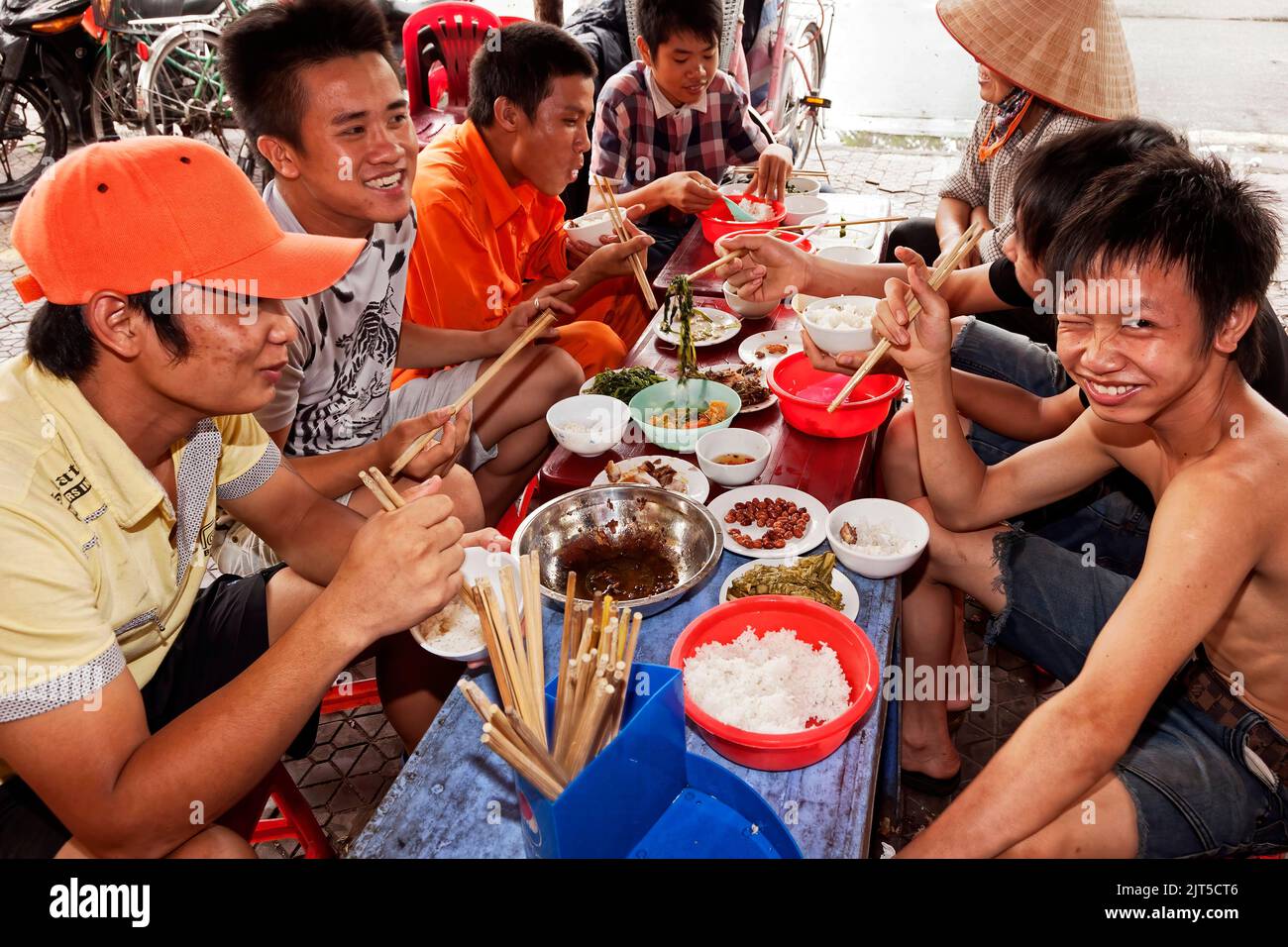 Vietnamese people eating at open air restaurant in the street, Hai Phong, Vietnam Stock Photo
