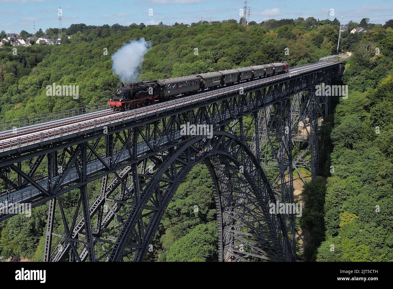 Solingen, Germany. 28th Aug, 2022. Near Solingen a steam locomotive drives over the 125 year old Müngsten bridge. (Aerial view with a drone) Credit: David Young/dpa/Alamy Live News Stock Photo