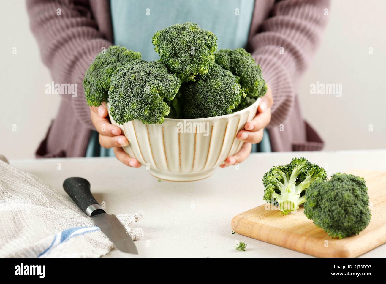 Female Hand Holding A Bowl of Broccoli, Concept Cooking Healthy Food Stock Photo