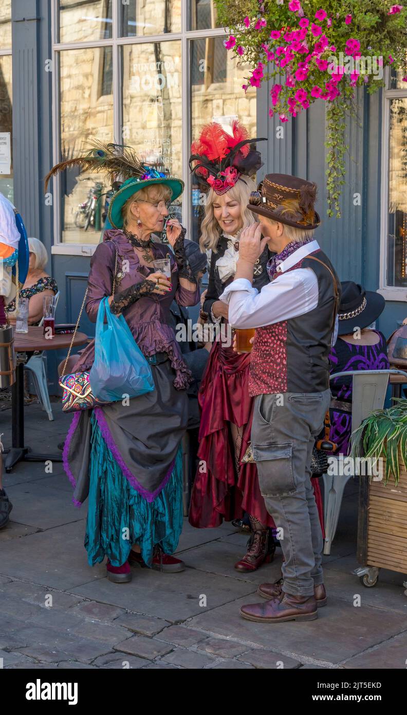 Three people enjoying conversation at the Lincoln Steampunk Festival, Lincoln 2022 Stock Photo