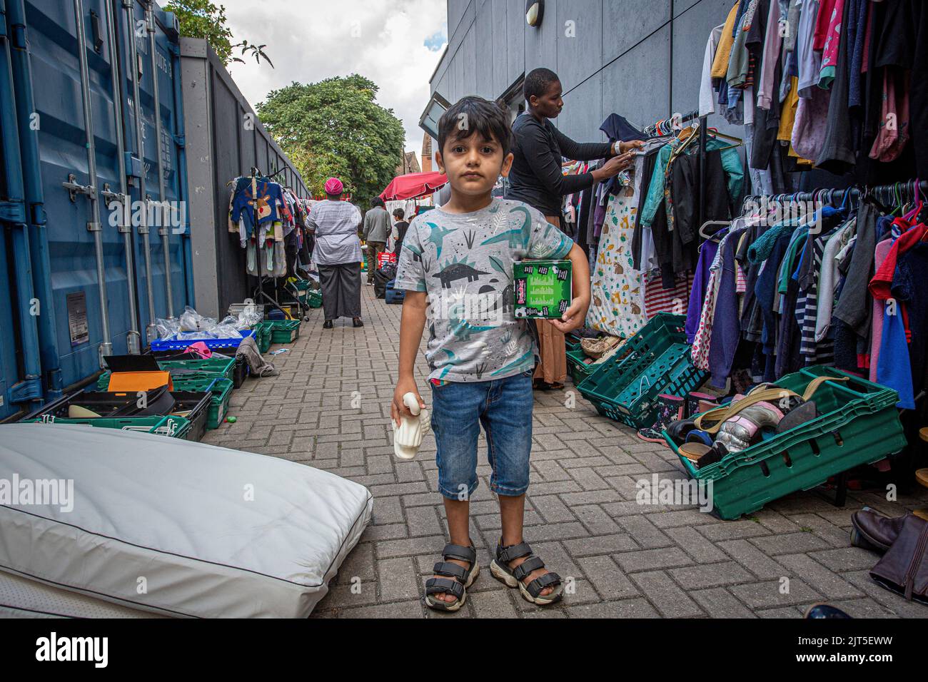 London ,24 August 2022 , Young boy collecting toys at Lewisham Donation Hub England . Stock Photo