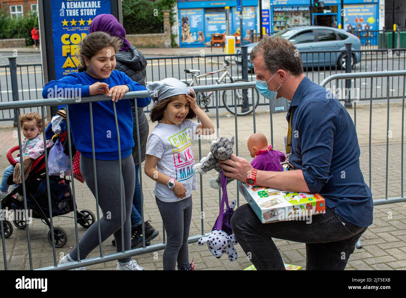 Laurence Smith from the Lewisham Donation Hub with young children  , London , England Stock Photo