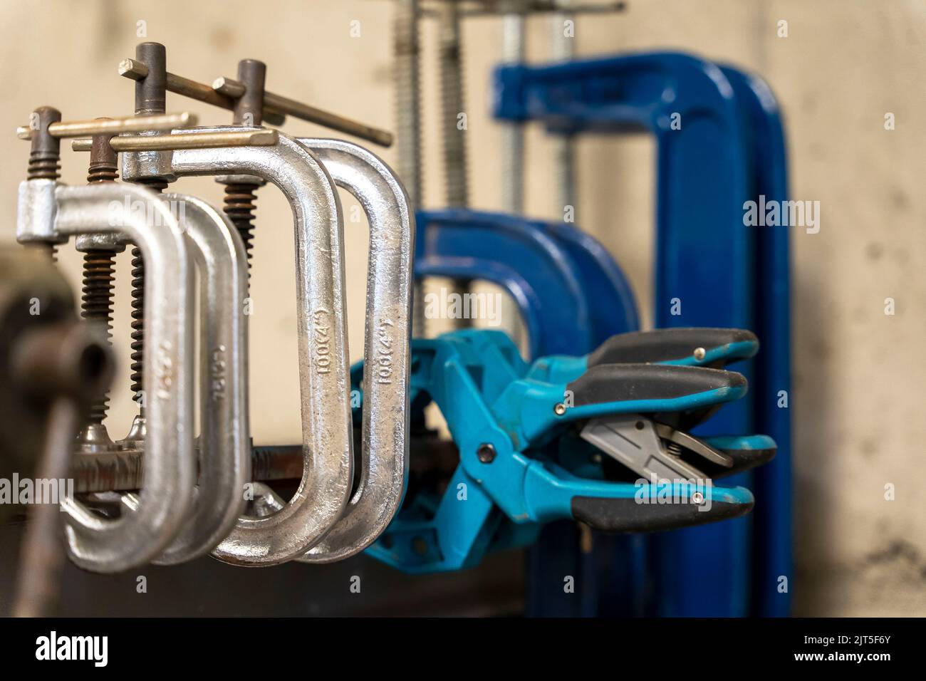 hand clamps on the welding table in the auto repair shop Stock Photo
