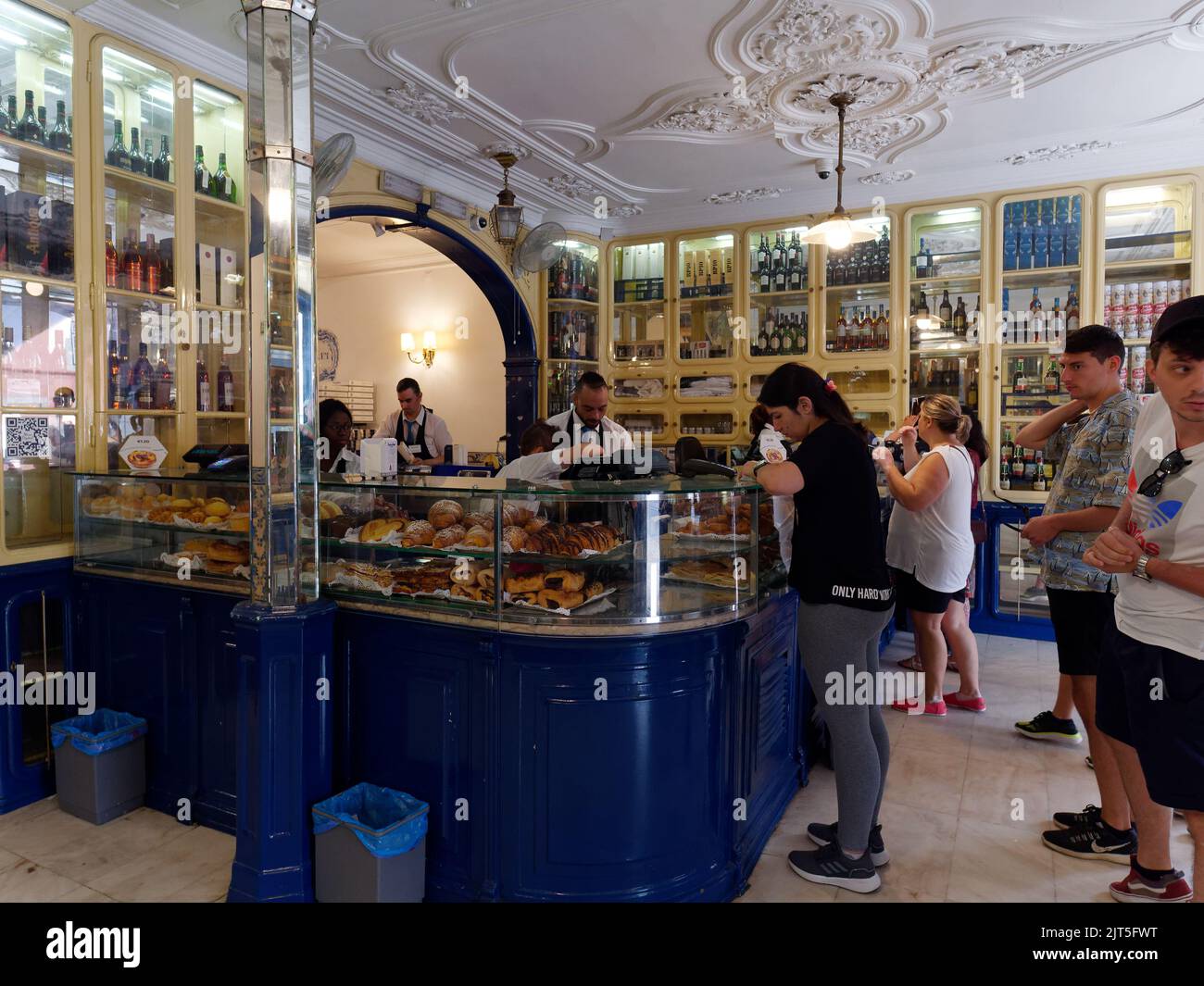 People queue in the interior of the famous Pasteis de Belem shop in the Belem district of Lisbon, Portugal. Stock Photo