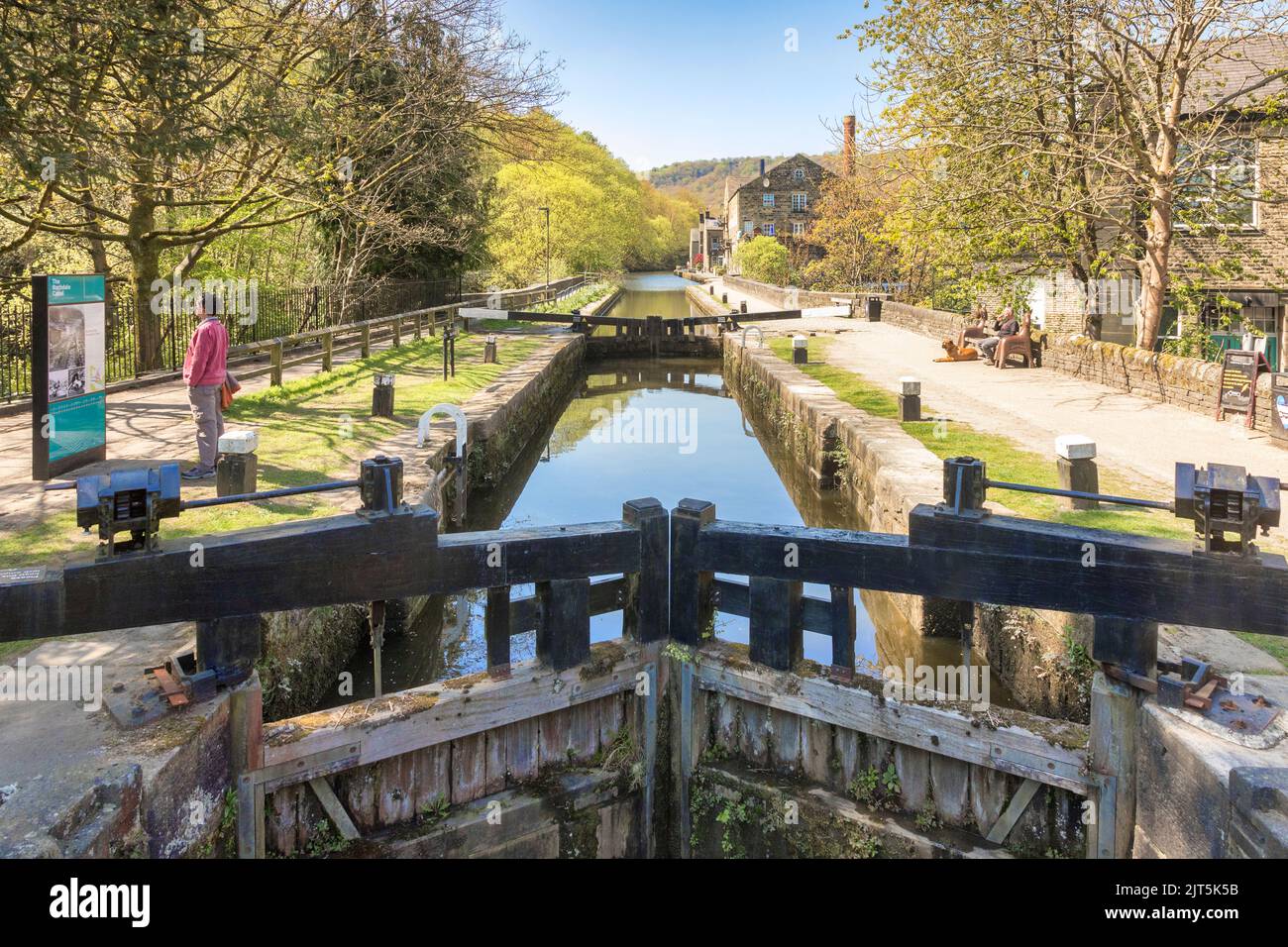29 April 2022: Hebden Bridge, West Yorkshire, UK - A view along the Rochdale Canal, with locks, people, sunshine. Stock Photo