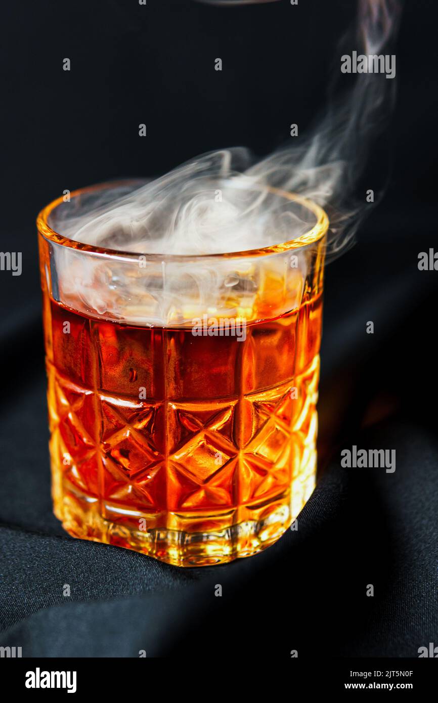 Alcoholic drink. A cocktail with whiskey or cognac with fire and smoke