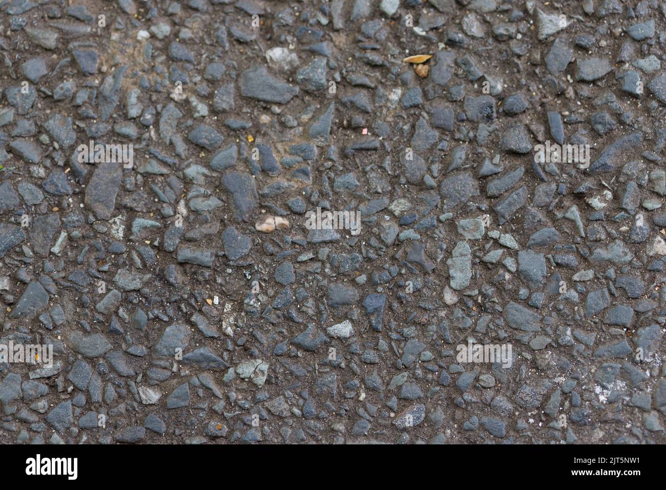 Black tar surface dirty with sand and dirt. Stock Photo