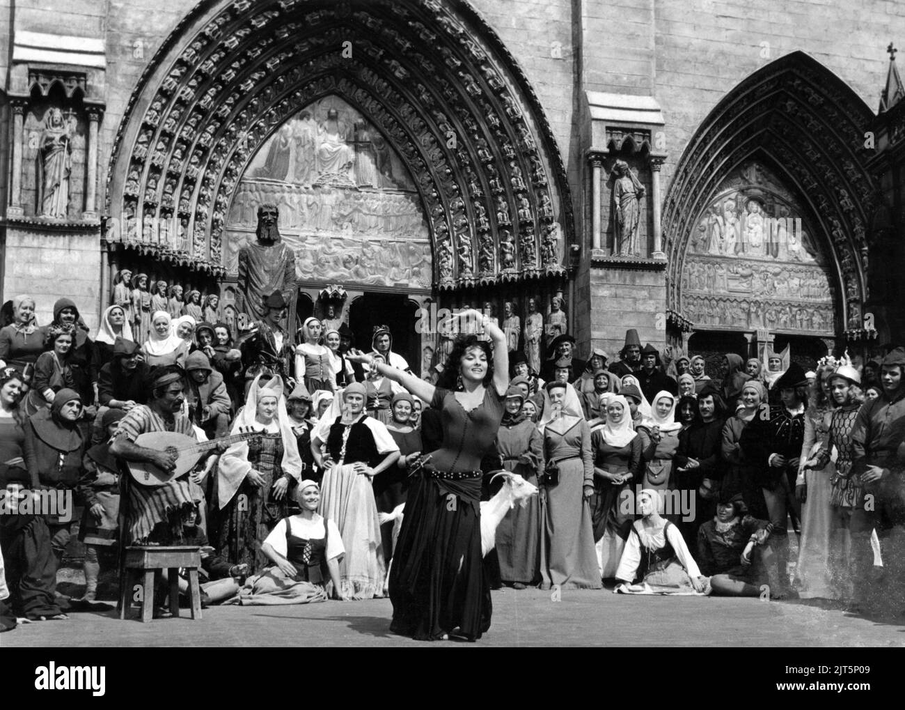 GINA LOLLOBRIGIDA as Esmeralda dancing outside the Cathedral in THE HUNCHBACK OF NOTRE DAME / NOTRE DAME DE PARIS 1956 director JEAN DELANNOY novel Victor Hugo adaptation / dialogue Jean Aurenche and Jacques Prevert music Georges Auric costume design Georges Benda production design Rene Renoux choreographer Leonid Massine producers Raymond and Robert Hakim France - Italy co-production Paris Film Productions / Panitalia Stock Photo