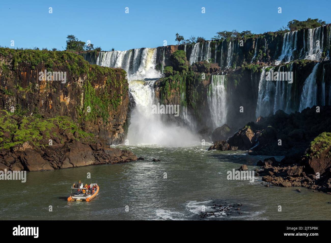 Tourist boat exploring Iguazu Falls on the border of Argentina and Brazil. Stock Photo