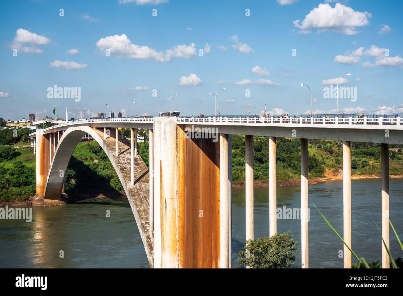 Friendship Bridge (Portuguese: Ponte da Amizade ) over the Parana river, connecting Foz do Iguacu, Brazil, to Ciudad del Este in Paraguay. Stock Photo