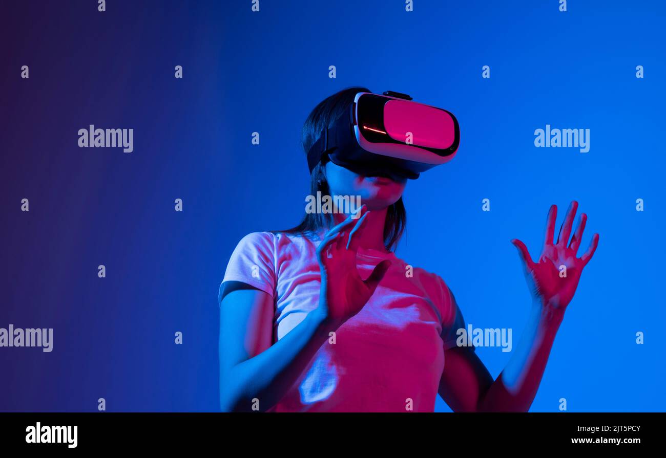 Young woman wearing VR headset while working with engineering project ...