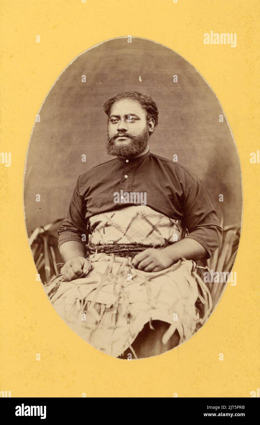Uelingatoni Ngū, sitting on a chair, wearing shirt and barkcloth wrap, Oc,B14.4, Stock Photo