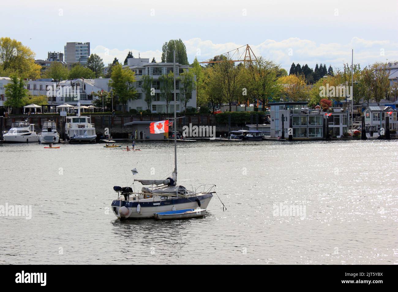 A Sailing boat with a Canadian flag at False Creek by downtown Vancouver, British Columbia, Canada Stock Photo