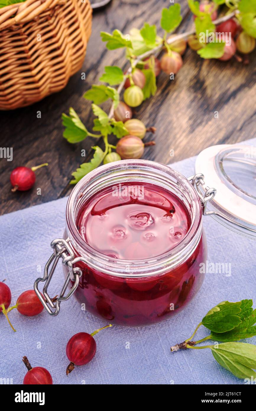 Homemade  gooseberry jam on table, outdoor shot Stock Photo