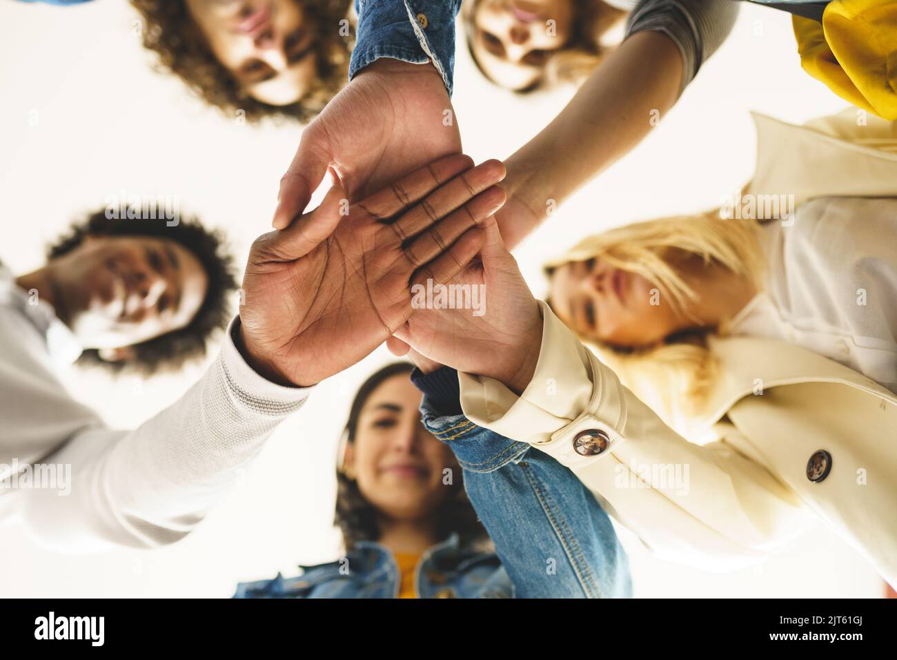 Diverse people stacking hands together Stock Photo Alamy