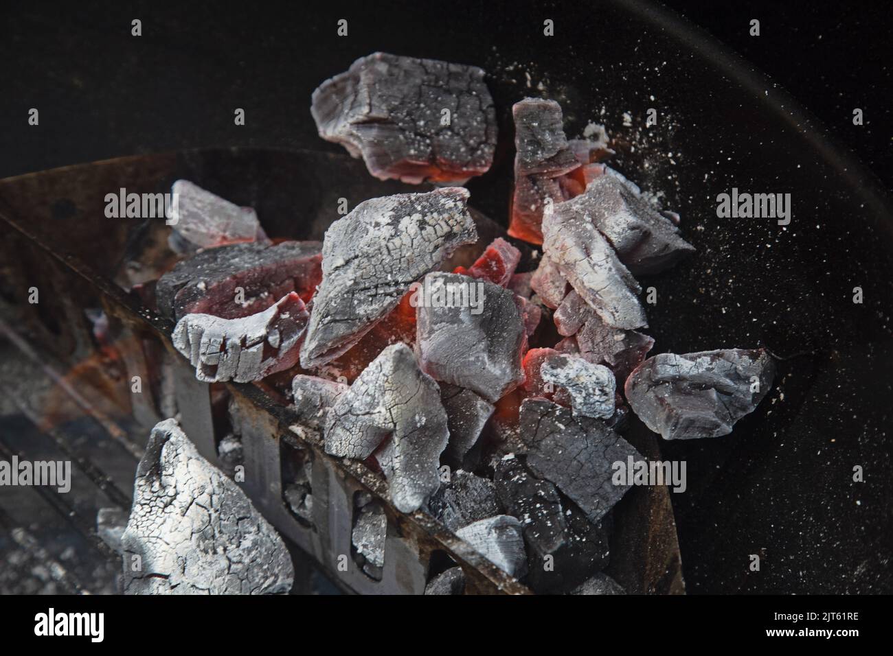 Lumpwood charcoal burning in a kettle barbecue pan, shot close up Stock Photo