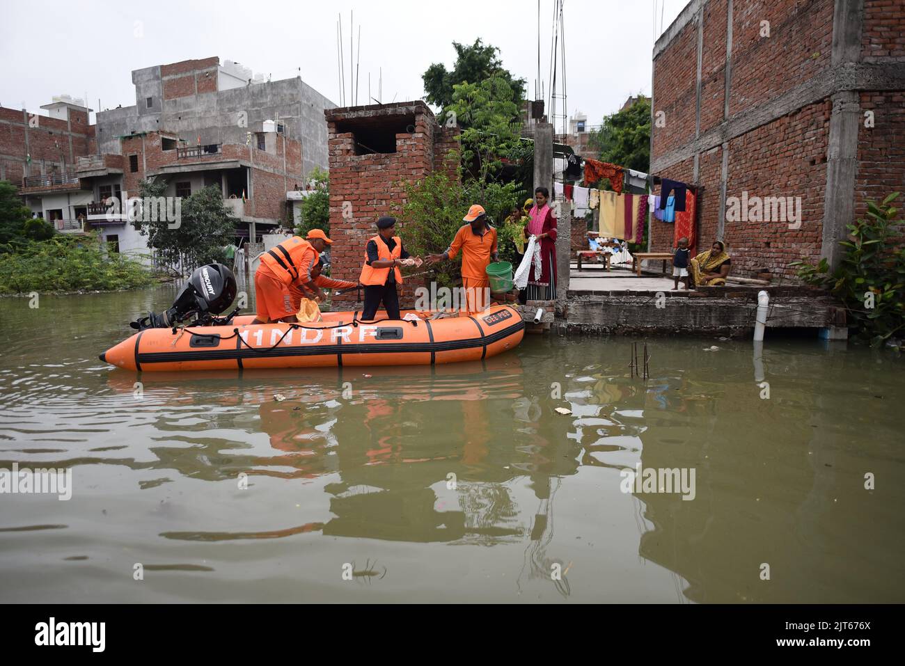 Uttar Pradesh. 28th Aug, 2022. Rescuers distribute relief supplies to flood-affected people in Prayagraj district of India's northern state of Uttar Pradesh, Aug. 28, 2022. Credit: Str/Xinhua/Alamy Live News Stock Photo
