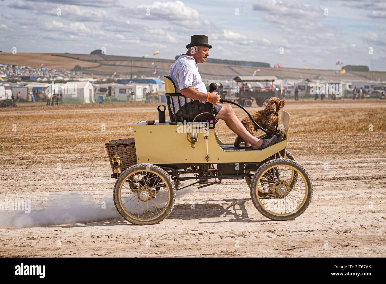 A man takes a dog for a ride in a steam powered vehicle during the Great Dorset Steam Fair at Tarrant Hinton, near Blandford Forum, Dorset. Picture date: Sunday October 22, 2017. Stock Photo