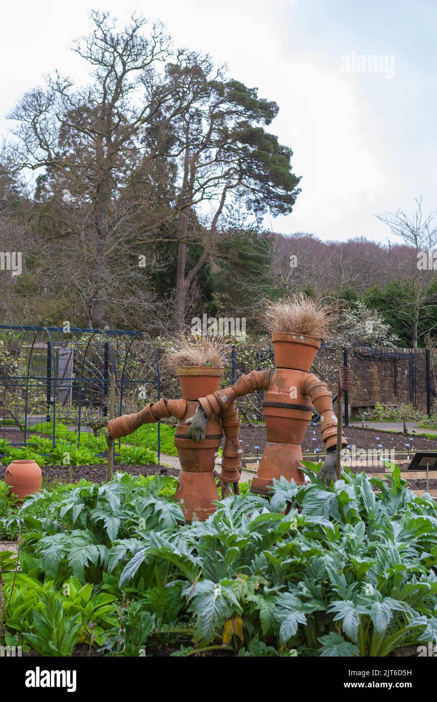 Eccentric scarecrows made of flowerpots in the Fruit and Vegetable Garden, RHS Rosemoor, Devon, UK Stock Photo